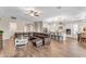 Open floor plan with spacious kitchen, stainless steel appliances, and adjacent living room with large sectional sofa at 21559 E Russet Rd, Queen Creek, AZ 85142