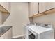 Laundry room with washer, dryer, and ample cabinet storage at 21559 E Russet Rd, Queen Creek, AZ 85142