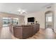 Spacious living room with a large sectional sofa and backyard access at 21559 E Russet Rd, Queen Creek, AZ 85142