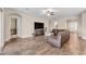 Bright living room featuring hardwood floors and a comfortable leather sectional sofa at 21559 E Russet Rd, Queen Creek, AZ 85142