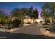 Luxury home with a brick driveway and desert landscaping at dusk at 25255 N Ranch Gate Rd, Scottsdale, AZ 85255