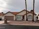 Single-story home with a two-car garage and desert landscaping at 26630 S Pinewood Dr # 14, Sun Lakes, AZ 85248