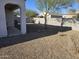 Small backyard with gravel, block wall, and a tree at 36408 W Montserrat St, Maricopa, AZ 85138