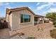 Tan house exterior with a covered patio at 425 S 225Th Ave, Buckeye, AZ 85326