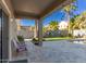 Covered patio overlooking a refreshing pool and grassy lawn at 44344 W Knauss Dr, Maricopa, AZ 85138
