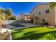 Spacious backyard with a large pool and grassy area at 44344 W Knauss Dr, Maricopa, AZ 85138