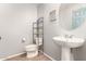 Clean bathroom with pedestal sink and storage at 44344 W Knauss Dr, Maricopa, AZ 85138