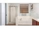 Bathroom features a shower and a bathtub with modern fixtures at 44344 W Knauss Dr, Maricopa, AZ 85138
