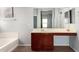 Bathroom boasts a large vanity with double sinks and a soaking tub at 44344 W Knauss Dr, Maricopa, AZ 85138