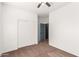 Bright bedroom with double doors and neutral carpeting at 44344 W Knauss Dr, Maricopa, AZ 85138