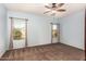 Bright bedroom with carpeted floor, ceiling fan, and window coverings at 44344 W Knauss Dr, Maricopa, AZ 85138