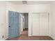 Bedroom with door to bathroom and double door closet at 44344 W Knauss Dr, Maricopa, AZ 85138