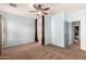 Bedroom with ceiling fan, carpet and en-suite bathroom at 44344 W Knauss Dr, Maricopa, AZ 85138