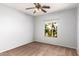 Well-lit bedroom with neutral walls, ceiling fan and large window at 44344 W Knauss Dr, Maricopa, AZ 85138