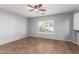 Dining room with tile floor, gray walls, and a ceiling fan at 44344 W Knauss Dr, Maricopa, AZ 85138