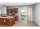 Kitchen with island, stainless steel appliances and backyard access at 44344 W Knauss Dr, Maricopa, AZ 85138