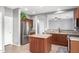 Kitchen boasts an island, stainless steel appliances, and ample cabinet space at 44344 W Knauss Dr, Maricopa, AZ 85138