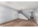 Living room with brown carpet, gray walls, and a staircase at 44344 W Knauss Dr, Maricopa, AZ 85138