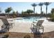 Community pool with lounge chairs and palm trees at 4831 W Dunbar Dr, Laveen, AZ 85339