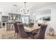 Elegant dining area with a large table, plush chairs, and a stylish chandelier at 6447 E Eugie Ter, Scottsdale, AZ 85254