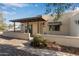 Front view of a single-story home with a covered porch and desert landscaping at 817 E Lancaster Cir, Florence, AZ 85132