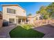 Landscaped backyard with patio and artificial turf at 10051 E Carmel Ave, Mesa, AZ 85208