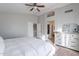 Main bedroom with king bed, dresser, and access to bath at 10051 E Carmel Ave, Mesa, AZ 85208