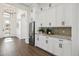 Bright entryway with white cabinetry, wine cooler, and wood flooring at 10835 N Cherry Hills Ct, Fountain Hills, AZ 85268