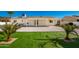 Backyard with covered patio and artificial turf at 13050 N 17Th Ave, Phoenix, AZ 85029