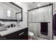 Modern bathroom with marble vanity and a glass shower at 13050 N 17Th Ave, Phoenix, AZ 85029