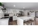 Modern kitchen boasts white cabinets, stainless steel appliances, and an island at 13050 N 17Th Ave, Phoenix, AZ 85029