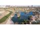 Aerial view of a golf course and lake, with city skyline in the background at 1345 W Edgemont Ave, Phoenix, AZ 85007