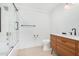 Clean bathroom with a modern vanity, bathtub, and glass shower doors at 1345 W Edgemont Ave, Phoenix, AZ 85007