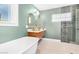 Updated bathroom features a soaking tub and stylish double vanity at 1345 W Edgemont Ave, Phoenix, AZ 85007
