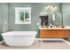 Modern bathroom with double vanity, freestanding tub, and walk-in shower at 1345 W Edgemont Ave, Phoenix, AZ 85007