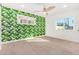 Bedroom with leafy wallpaper, ceiling fan, and ample natural light at 1345 W Edgemont Ave, Phoenix, AZ 85007