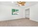 Bright bedroom with neutral carpeting, ceiling fan, and spacious closet at 1345 W Edgemont Ave, Phoenix, AZ 85007