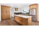 Modern kitchen with stainless steel appliances and light wood cabinets at 1345 W Edgemont Ave, Phoenix, AZ 85007