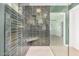 Spa-like shower with green tile, built-in seat, and glass enclosure at 1345 W Edgemont Ave, Phoenix, AZ 85007