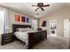 Bright bedroom with king-size bed, ceiling fan, and large closet at 15516 W Meadowbrook Ave, Goodyear, AZ 85395