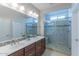 Elegant bathroom with double sinks and a walk-in shower at 16762 W Sheridan St, Goodyear, AZ 85395