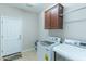 Convenient laundry room with washer, dryer and extra storage at 16762 W Sheridan St, Goodyear, AZ 85395