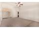 Bright living room with neutral carpeting and a ceiling fan at 1716 N Temple St, Mesa, AZ 85203