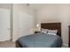 Light and airy bedroom with a dark-wood bed frame and closet at 21519 N 61St St, Phoenix, AZ 85054