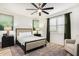 Cozy bedroom with a queen-size bed, ceiling fan, and window with plantation shutters at 33907 N 29Th Dr, Phoenix, AZ 85085