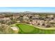 Aerial view of a luxury home community with a golf course and mountain views at 3414 N Park St, Buckeye, AZ 85396