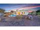 Desert landscape with a kidney-shaped pool and fire pit at 3414 N Park St, Buckeye, AZ 85396