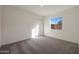 Simple bedroom with carpet flooring and a window at 4079 N Ghost Hollow Way, Casa Grande, AZ 85122