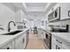Open concept kitchen with white cabinets, stainless steel appliances, and breakfast bar at 4141 N 31St St # 414, Phoenix, AZ 85016