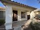 Covered front porch with a brown door and sidelights at 4544 N 129Th Ave, Litchfield Park, AZ 85340